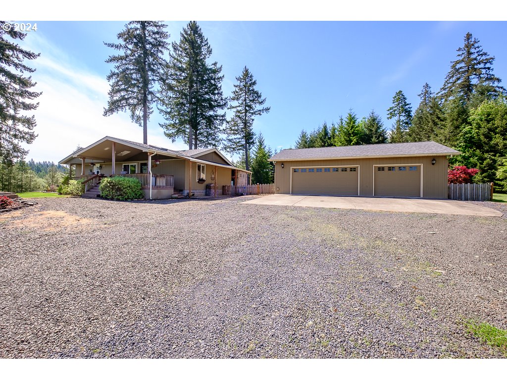 34221 Bond Road Lebanon, OR 97355 - Photo 1 of 45 a view of a house with a yard and large trees