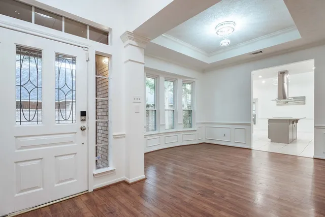 a view of livingroom with furniture wooden floor fireplace and windows