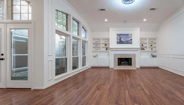 wooden floor in an empty room with a window