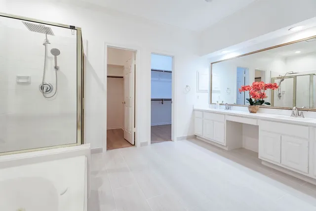 an empty room with wooden floor and chandelier fan