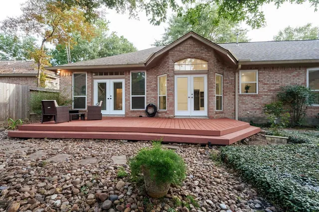 a view of a livingroom with wooden floor and a fireplace
