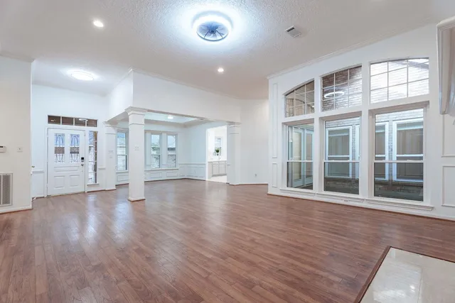 wooden floor in an empty room with a window