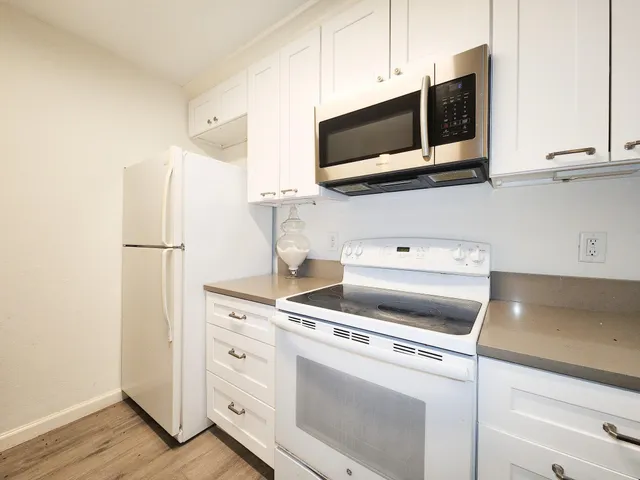 a stove top oven sitting inside of a kitchen
