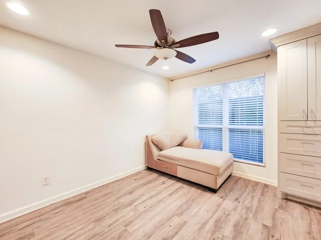 a living room with a bed furniture and a large window