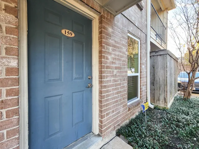 a view of front door of house with stairs