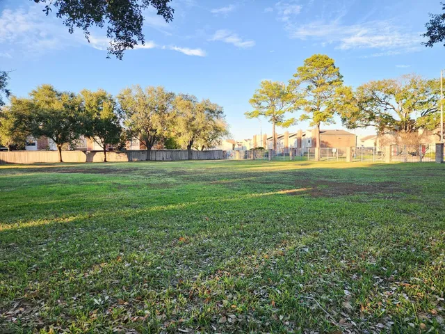 a view of outdoor space with green field and trees