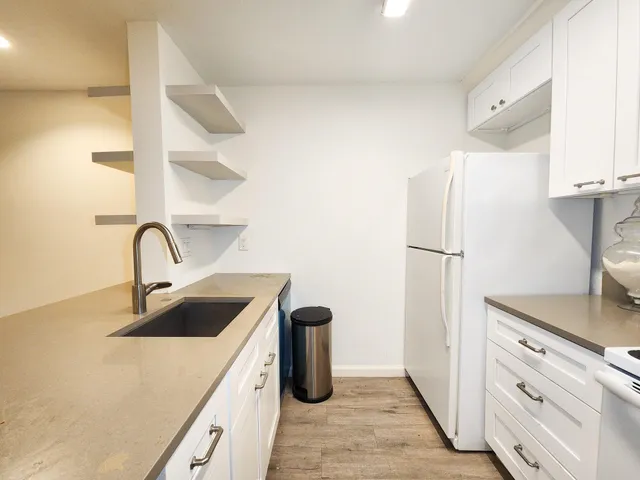 a kitchen with a refrigerator and a sink