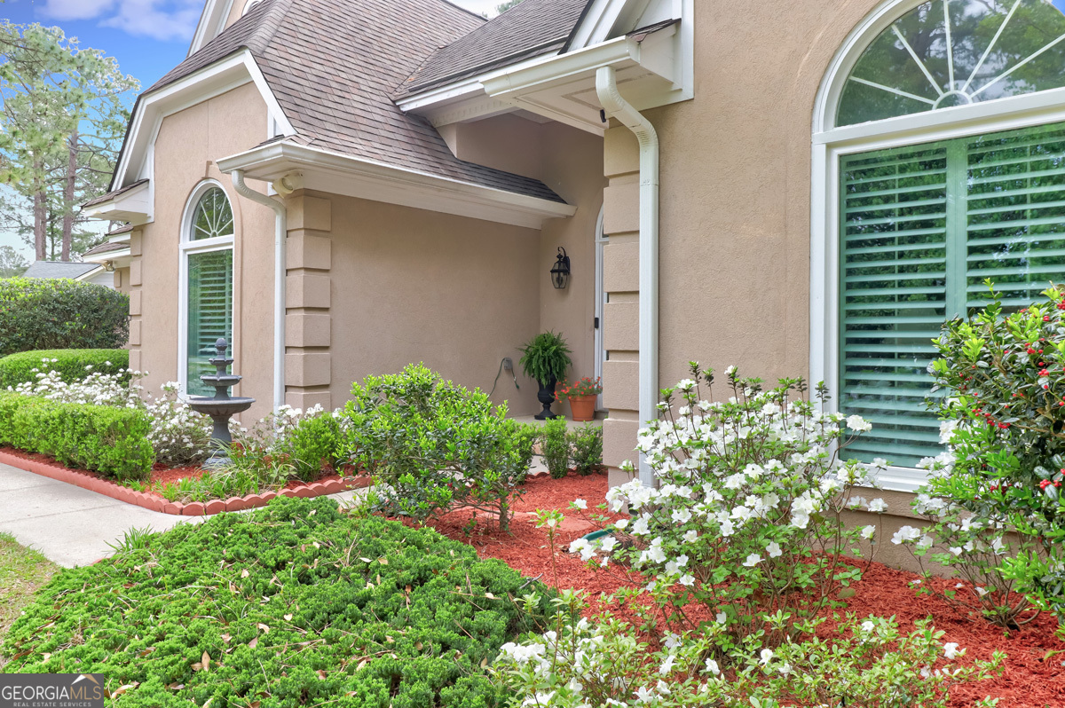 109 St Andrews Road Rincon, GA 31326 - Photo 12 of 52 front view of a house with potted plants