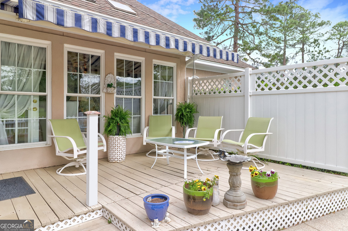 109 St Andrews Road Rincon, GA 31326 - Photo 13 of 52 a view of a patio with dining table and chairs and potted plants