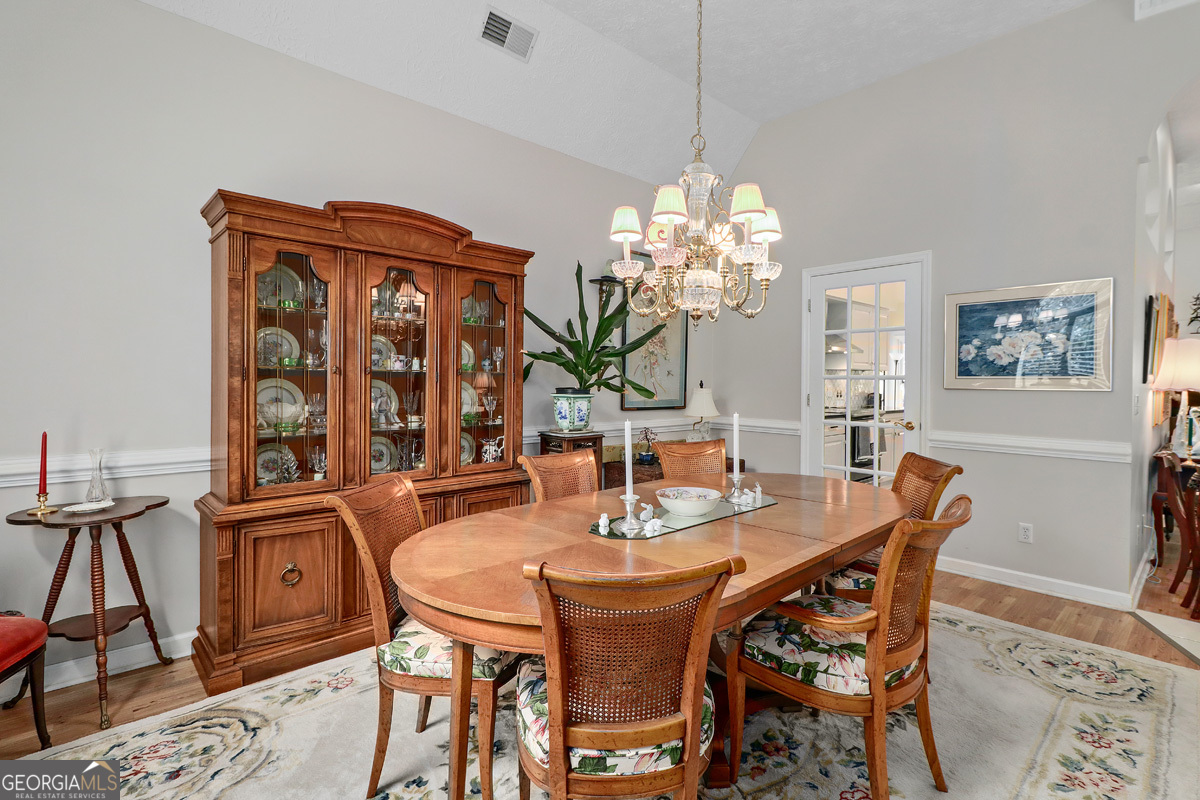 109 St Andrews Road Rincon, GA 31326 - Photo 16 of 52 a dining room with furniture a chandelier and window