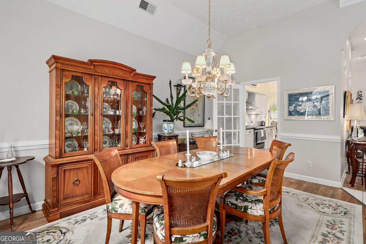 109 St Andrews Road Rincon, GA 31326 - Photo 17 of 52 a dining room with furniture a chandelier and window