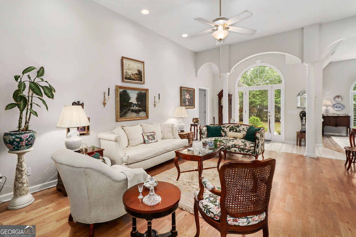 109 St Andrews Road Rincon, GA 31326 - Photo 19 of 52 a living room with furniture a chandelier and a large window