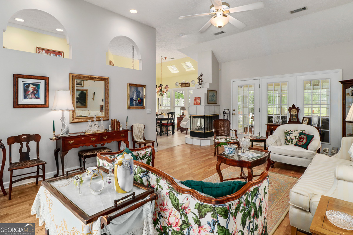 109 St Andrews Road Rincon, GA 31326 - Photo 20 of 52 a living room with furniture a chandelier and a dining table