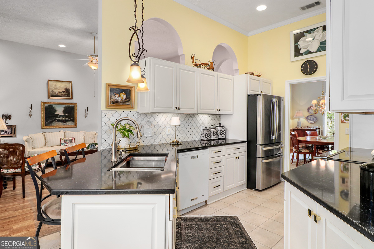 109 St Andrews Road Rincon, GA 31326 - Photo 23 of 52 a kitchen with stainless steel appliances granite countertop a sink stove and refrigerator