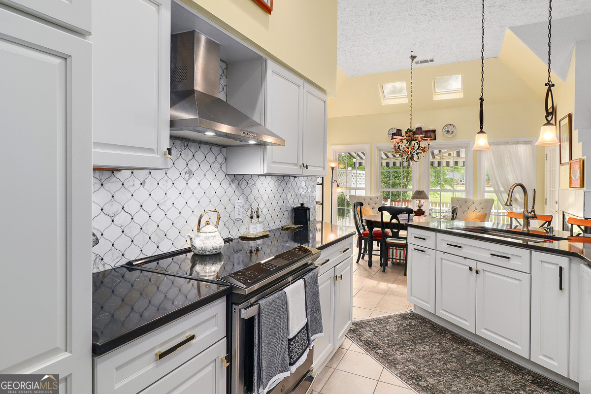 109 St Andrews Road Rincon, GA 31326 - Photo 24 of 52 a kitchen with stainless steel appliances granite countertop a sink stove and cabinets