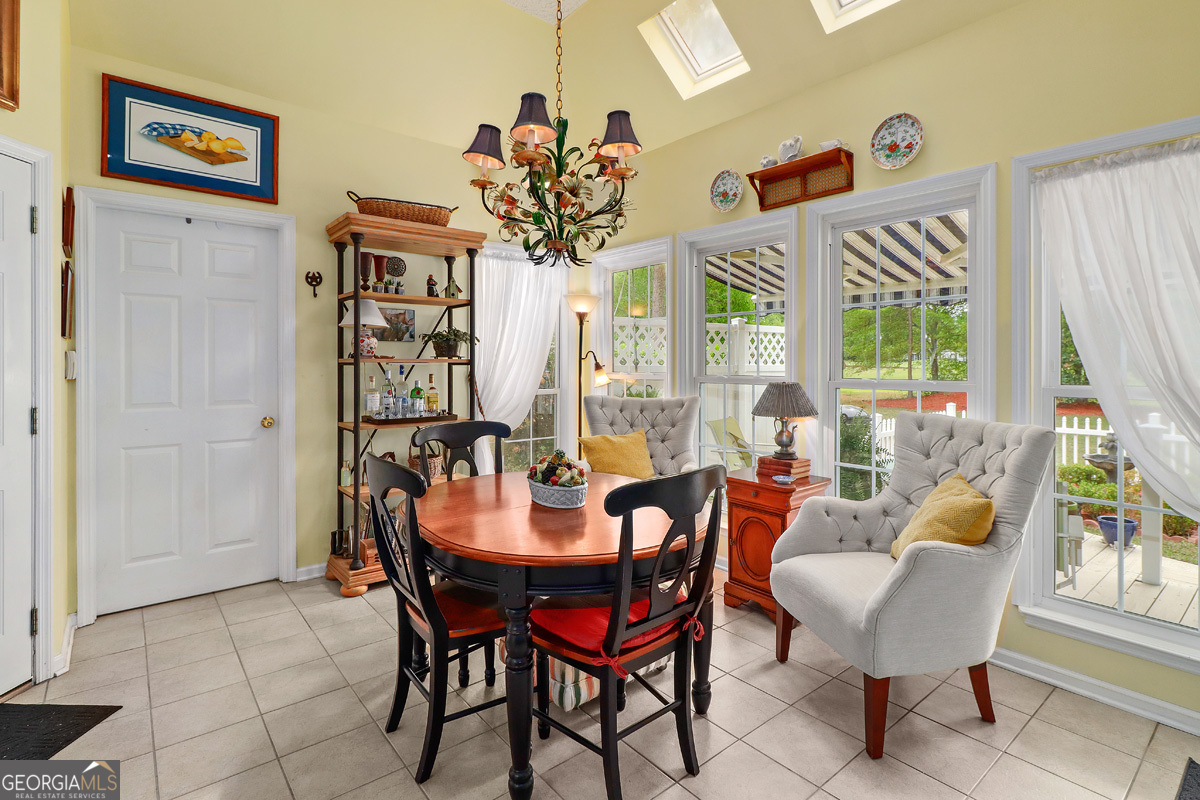 109 St Andrews Road Rincon, GA 31326 - Photo 26 of 52 a dining room with furniture a rug and a large window