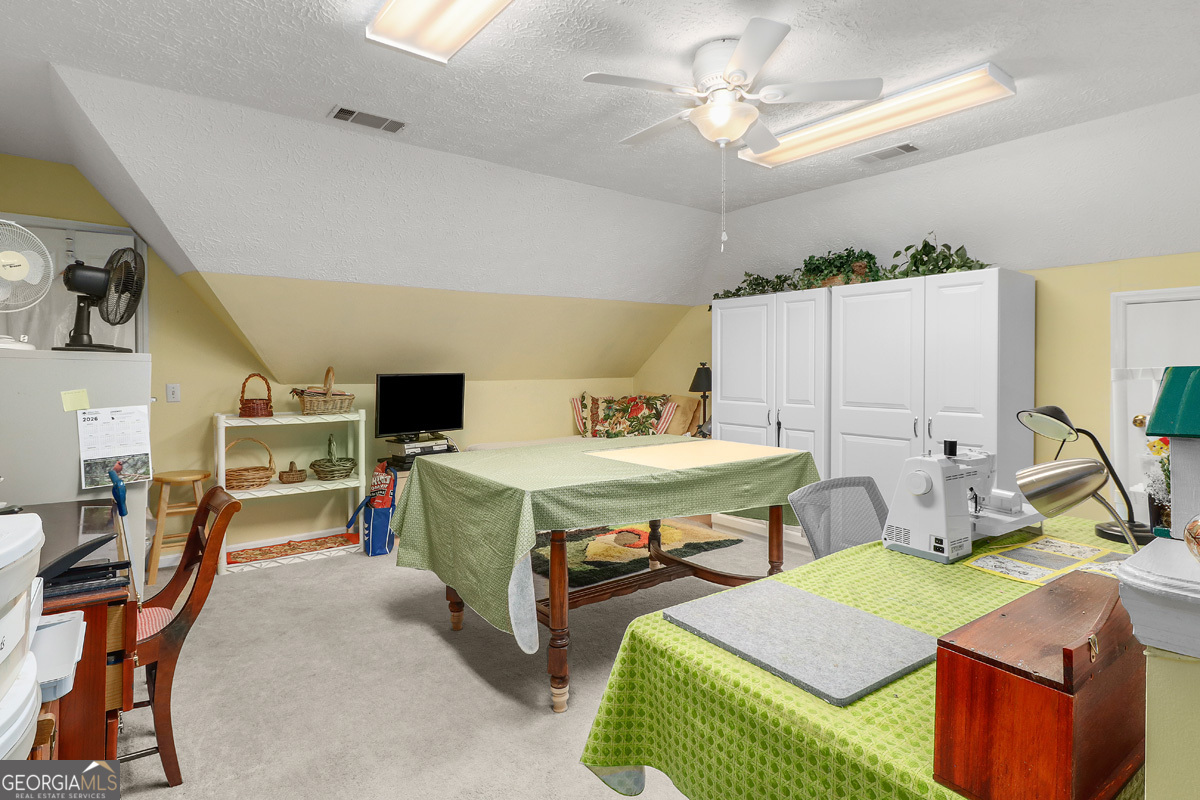 109 St Andrews Road Rincon, GA 31326 - Photo 29 of 52 a bedroom with furniture and a chandelier