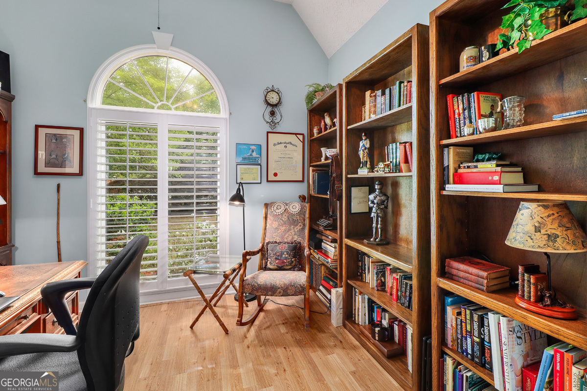 109 St Andrews Road Rincon, GA 31326 - Photo 31 of 52 a view of a workspace with furniture and a book shelf