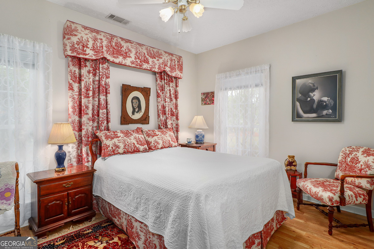 109 St Andrews Road Rincon, GA 31326 - Photo 34 of 52 a bedroom with a bed and a chandelier