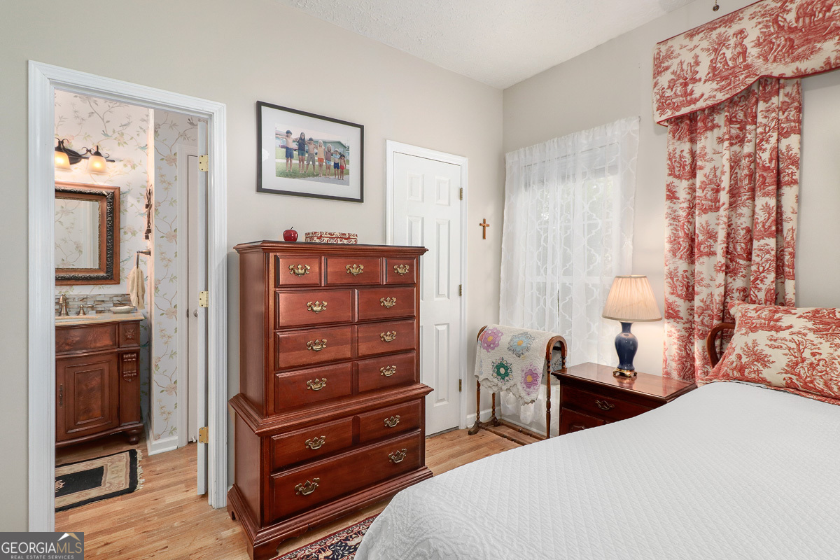 109 St Andrews Road Rincon, GA 31326 - Photo 35 of 52 a bedroom with a bed and wooden floor