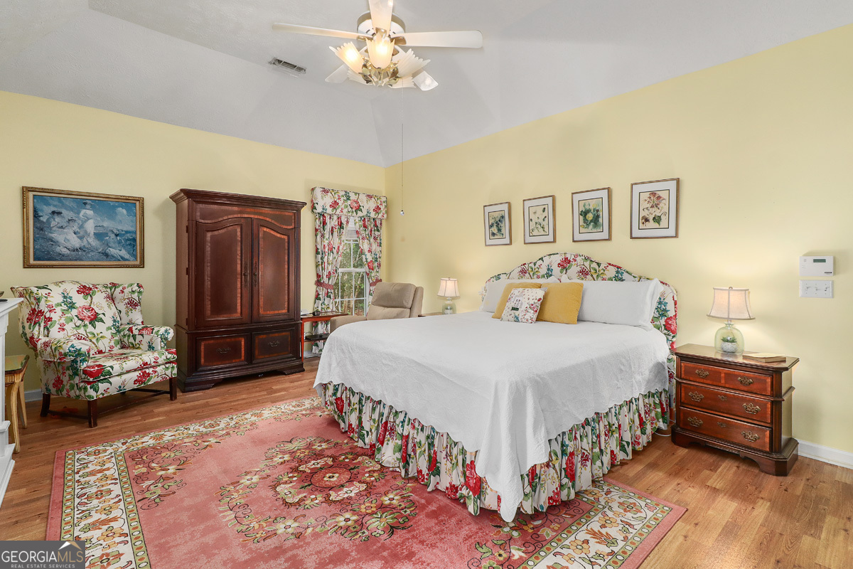 109 St Andrews Road Rincon, GA 31326 - Photo 36 of 52 a bedroom with a bed and a chandelier
