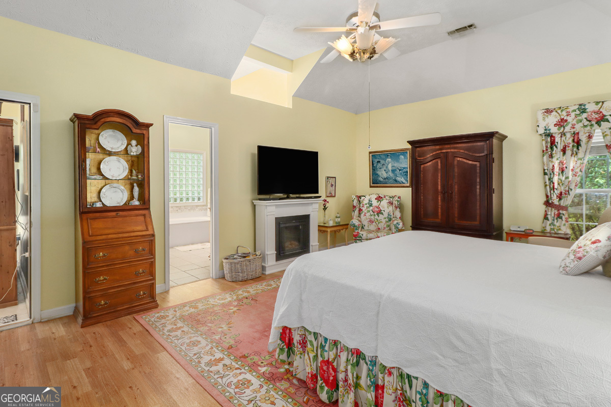 109 St Andrews Road Rincon, GA 31326 - Photo 37 of 52 a spacious bedroom with a bed and a flat screen tv