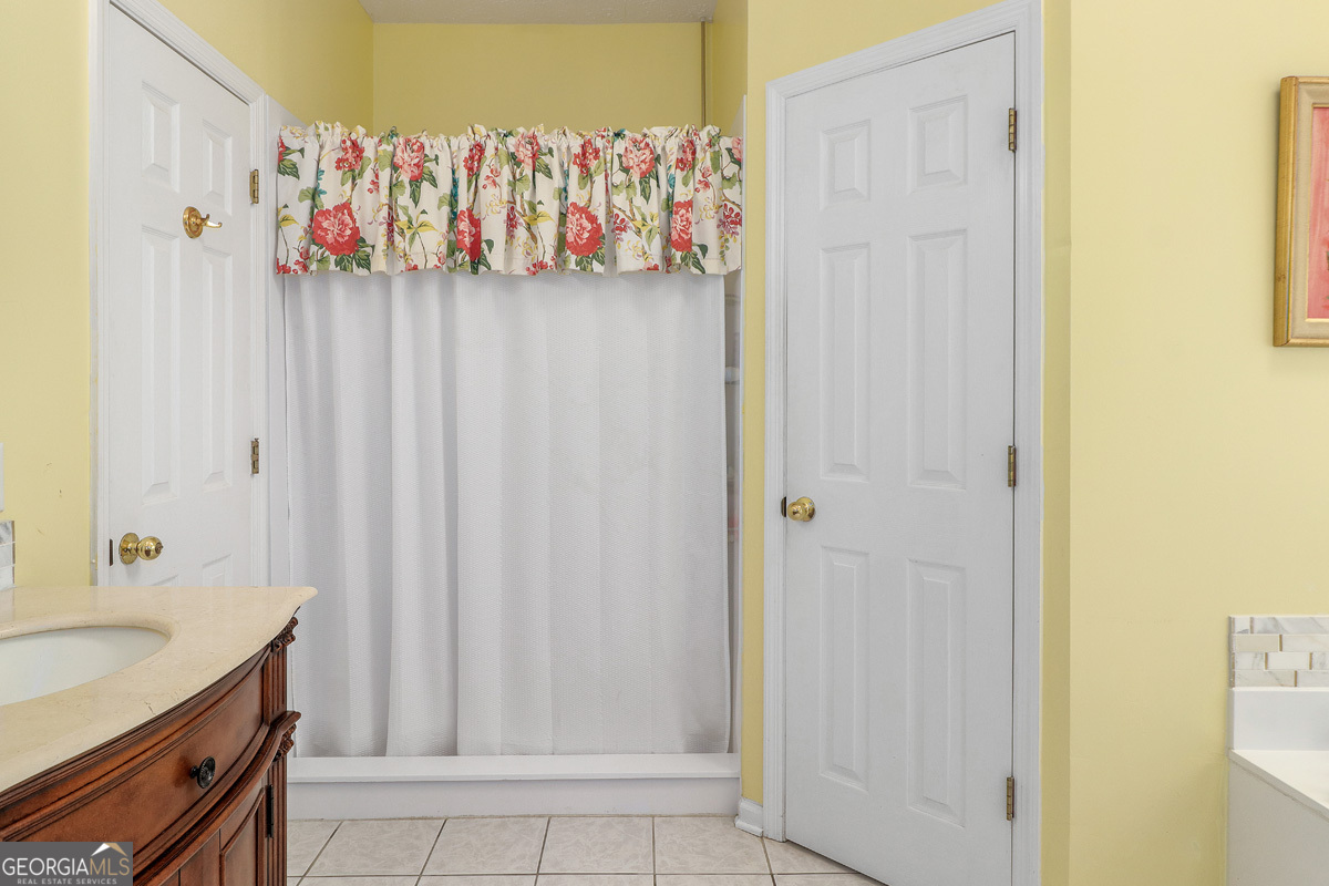 109 St Andrews Road Rincon, GA 31326 - Photo 40 of 52 a bathroom with a shower curtain and a sink