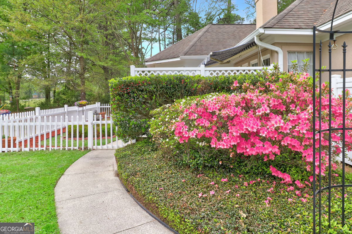 109 St Andrews Road Rincon, GA 31326 - Photo 49 of 52 a front view of house and yard with beautiful flowers and green space
