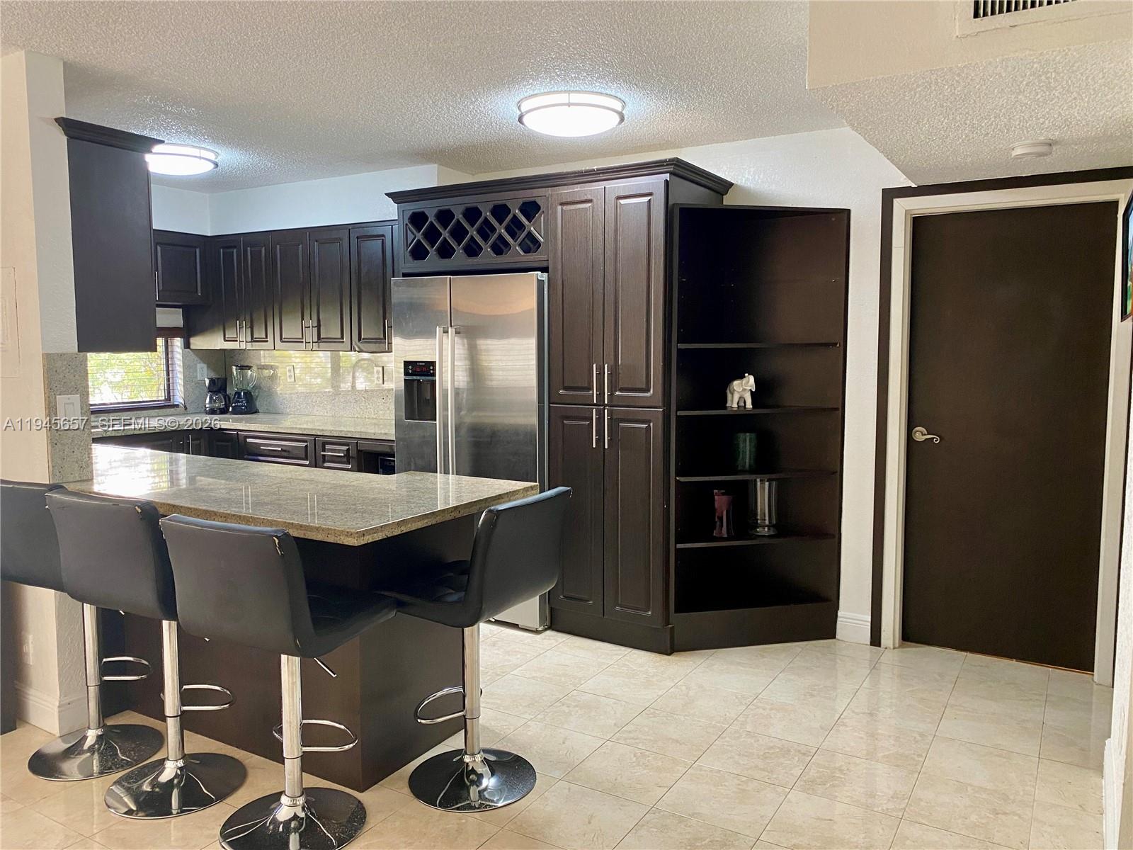 a kitchen with stainless steel appliances a refrigerator and a sink