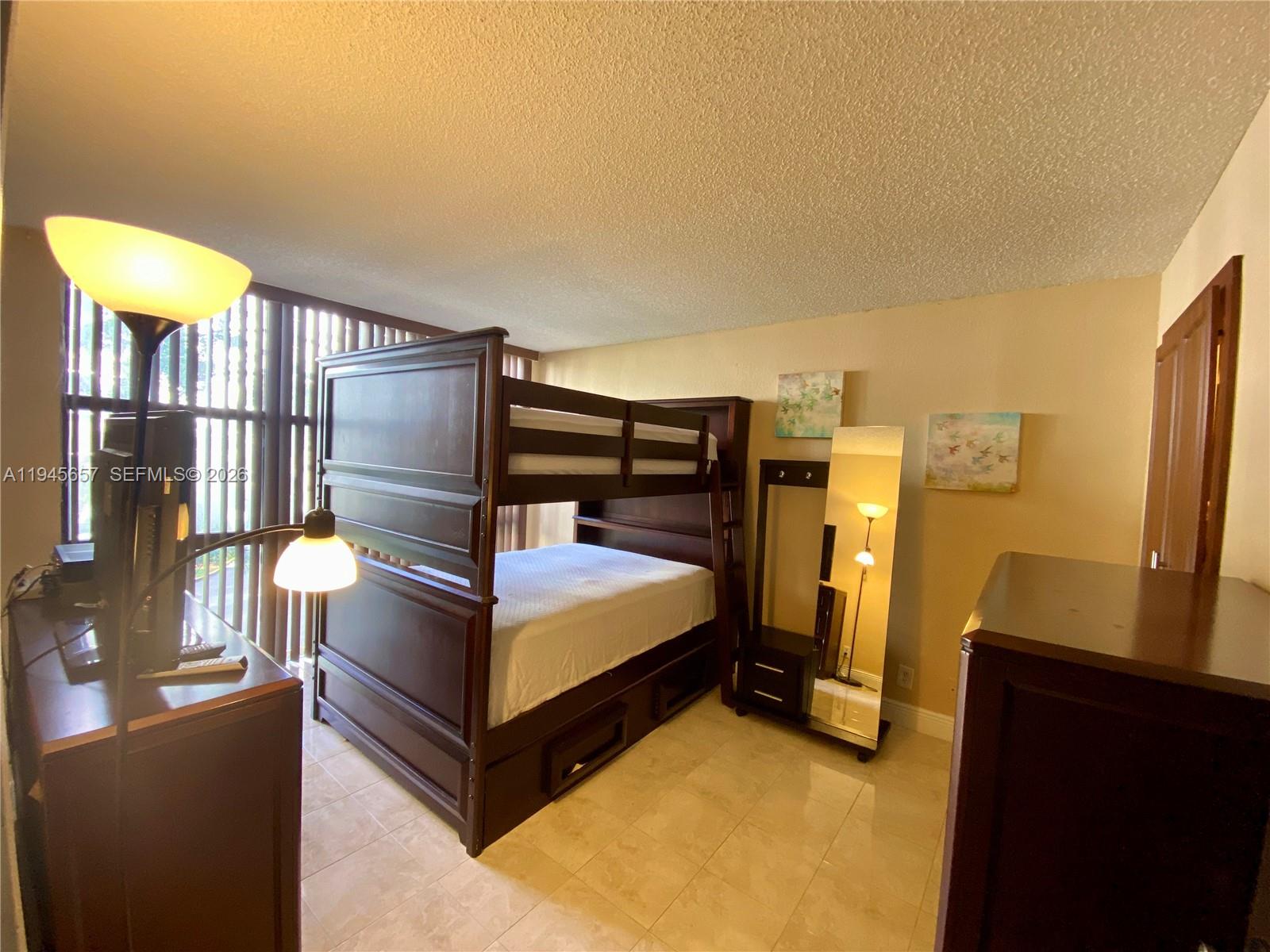 17011 North Bay Road, Unit 304 Sunny Isles Beach, FL 33160 - Photo 29 of 54 a bedroom with a bed and a refrigerator