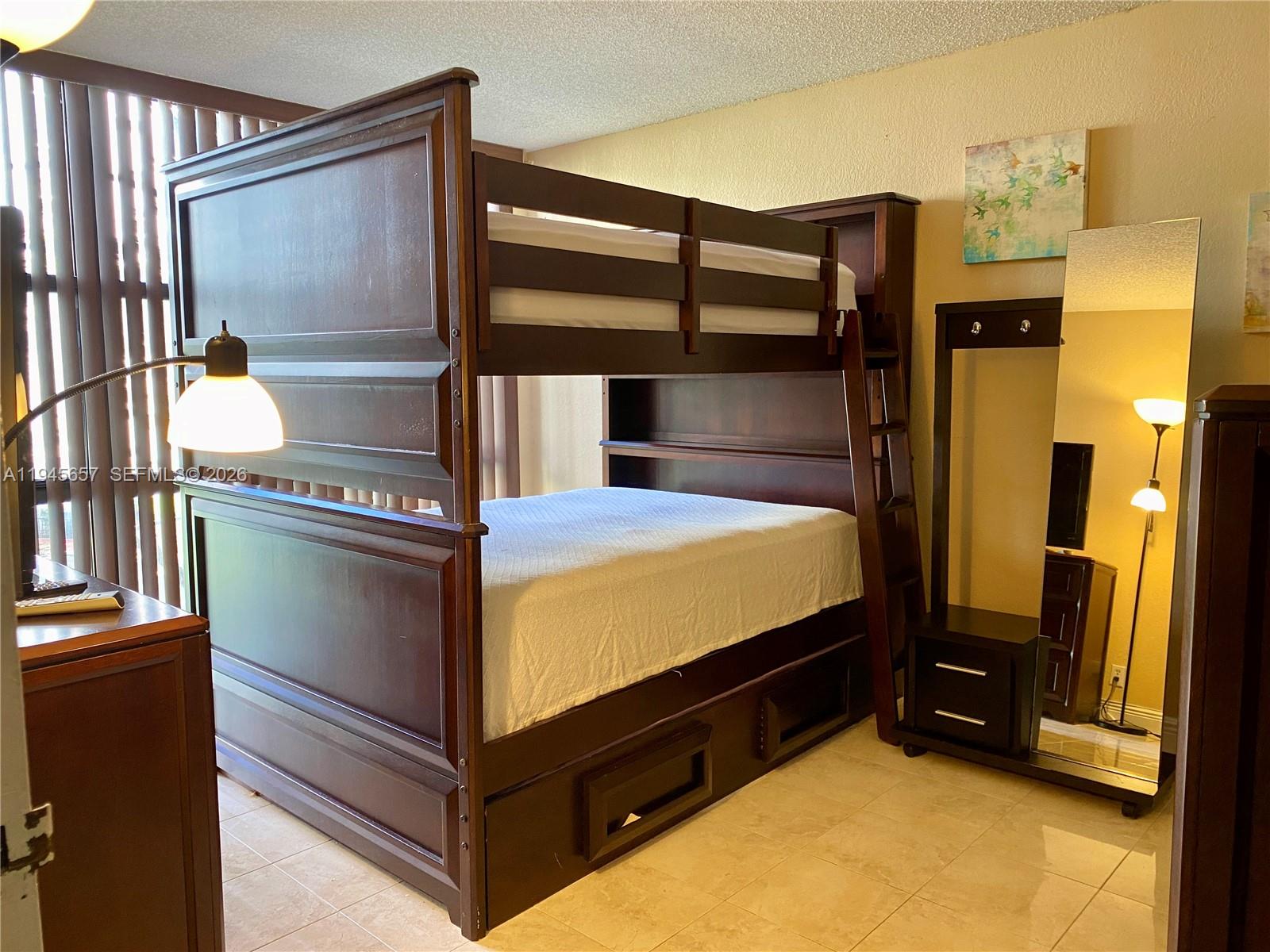 17011 North Bay Road, Unit 304 Sunny Isles Beach, FL 33160 - Photo 3 of 54 a bed room with a bed and a television