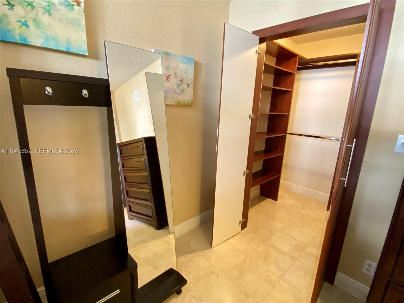 17011 North Bay Road, Unit 304 Sunny Isles Beach, FL 33160 - Photo 36 of 54 a view of walk in closet with empty racks