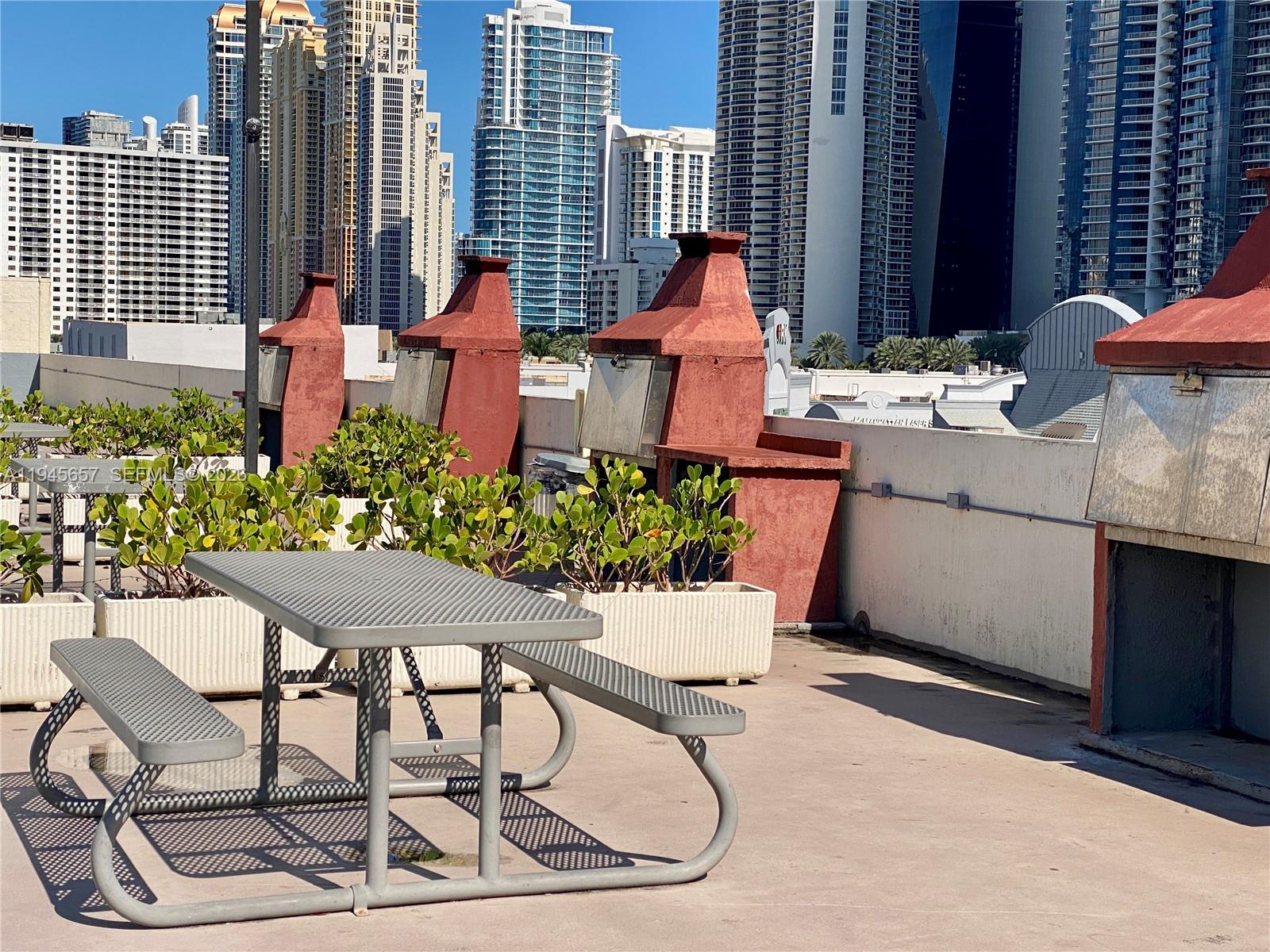 17011 North Bay Road, Unit 304 Sunny Isles Beach, FL 33160 - Photo 44 of 54 a outdoor dining space with furniture and a potted plant