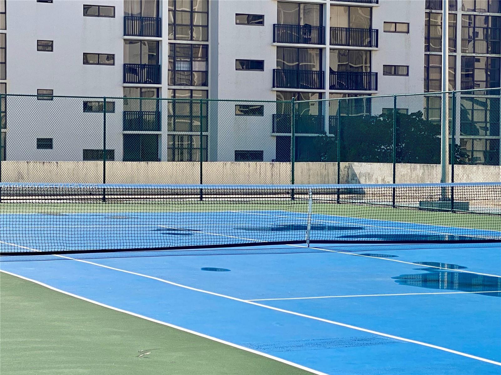 17011 North Bay Road, Unit 304 Sunny Isles Beach, FL 33160 - Photo 45 of 54 a view of a tennis court
