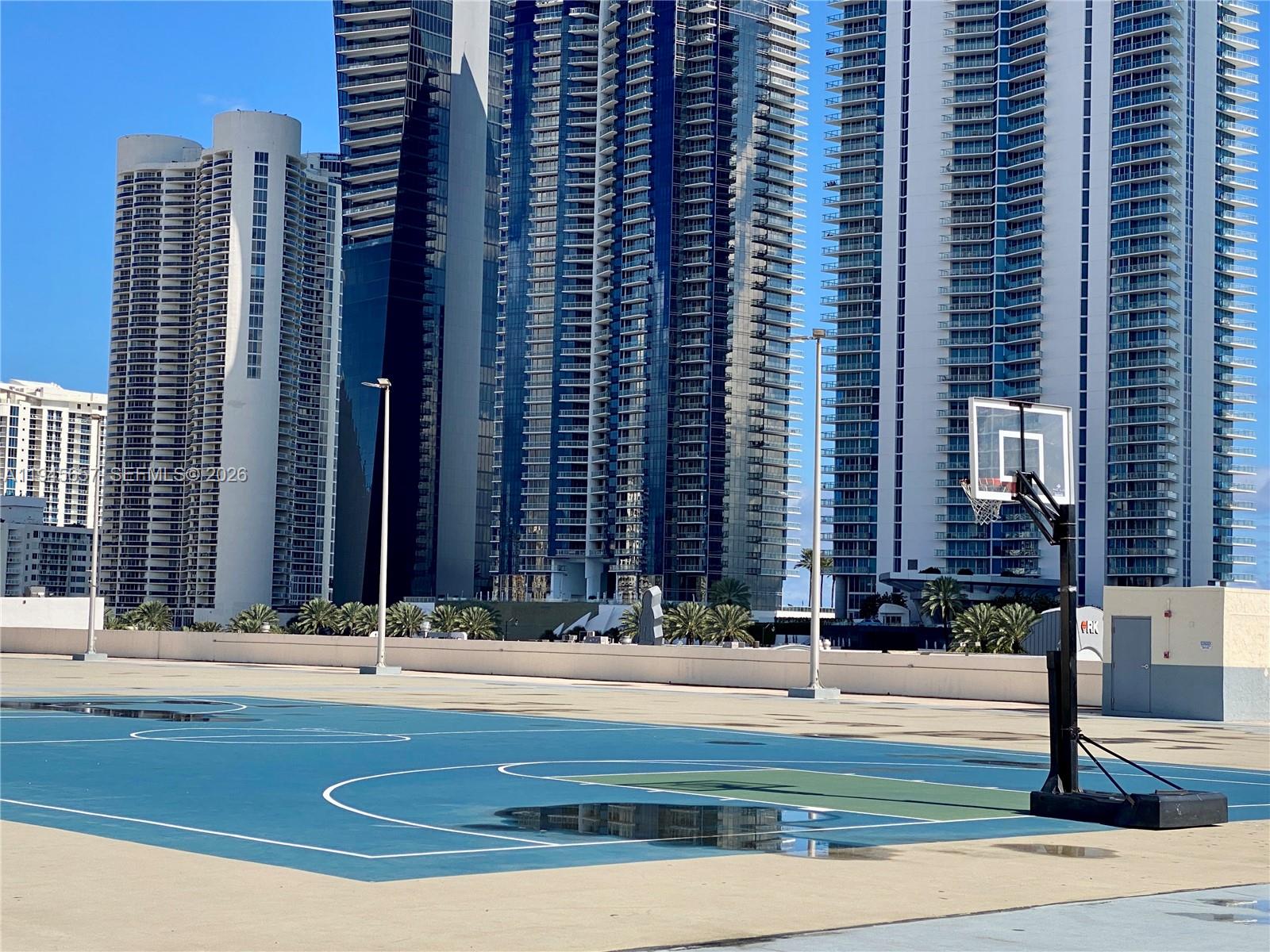 17011 North Bay Road, Unit 304 Sunny Isles Beach, FL 33160 - Photo 47 of 54 a view of building with yard and traffic signal