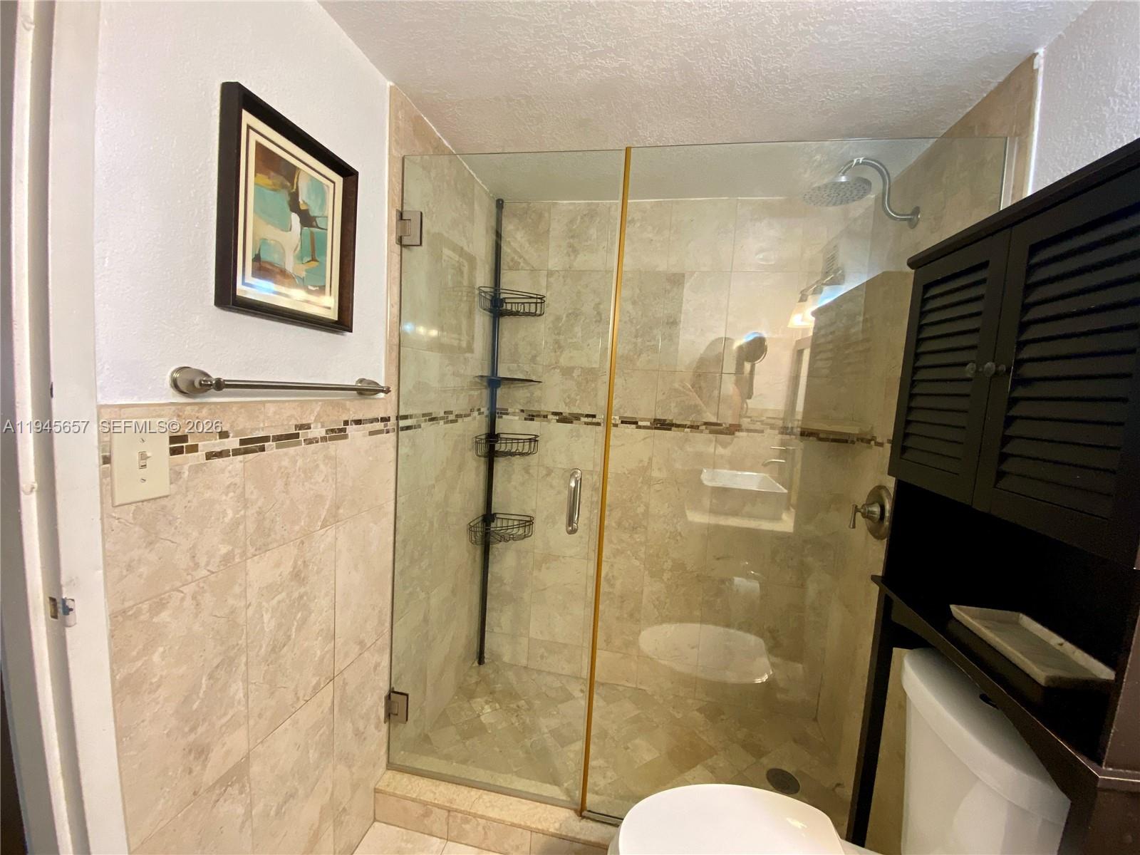 17011 North Bay Road, Unit 304 Sunny Isles Beach, FL 33160 - Photo 7 of 54 a bathroom with a shower toilet and sink