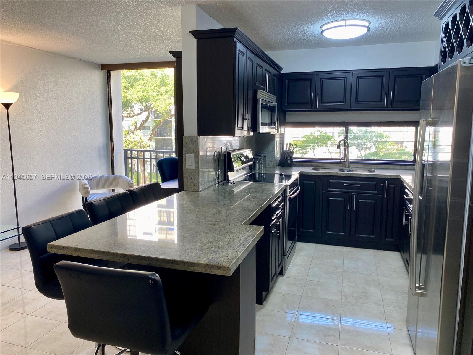 17011 North Bay Road, Unit 304 Sunny Isles Beach, FL 33160 - Photo 9 of 54 a kitchen with a sink and a window