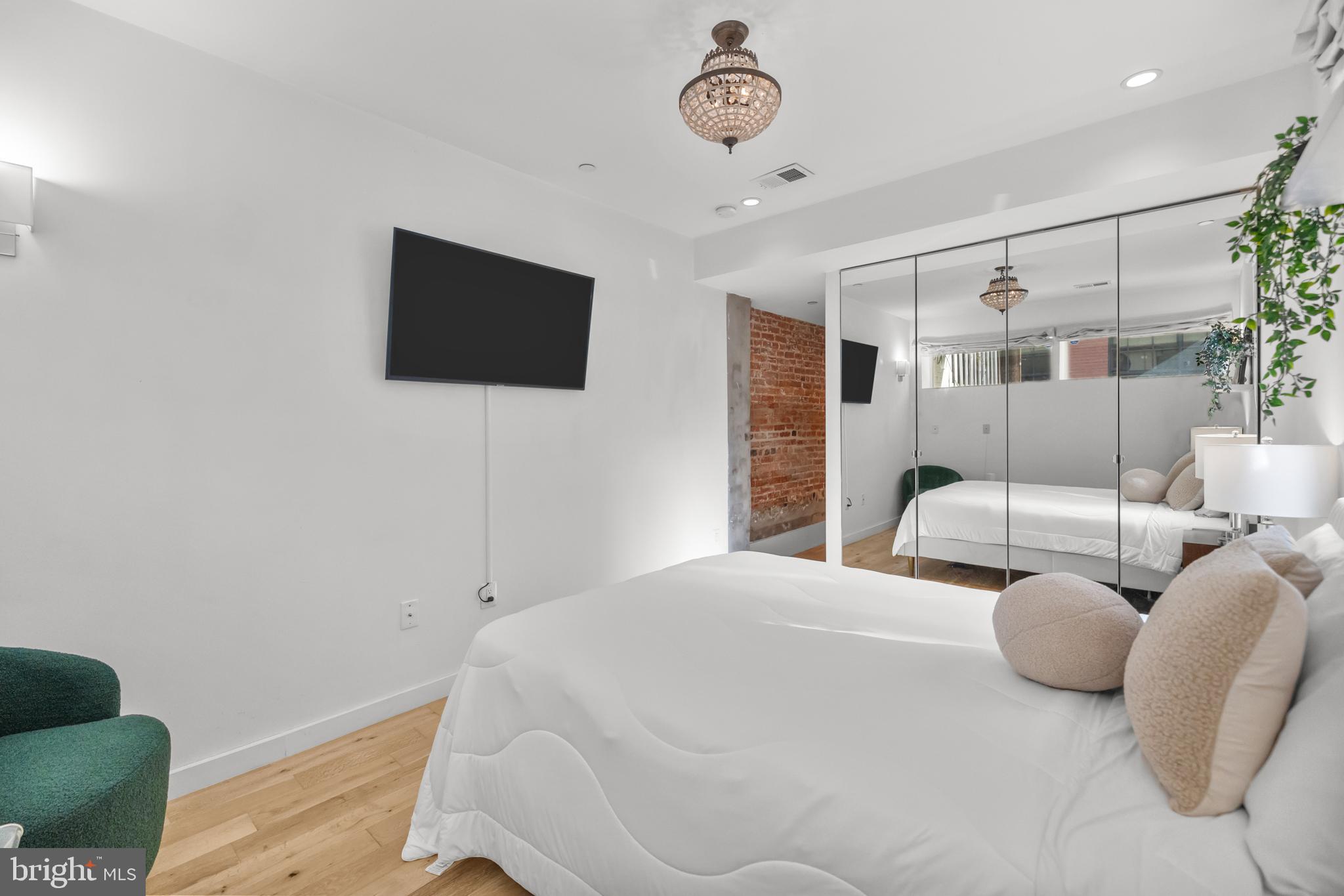1324 W Street Northwest, Unit 1 Washington, DC 20009 - Photo 19 of 37 a bedroom with a bed and a flat screen tv