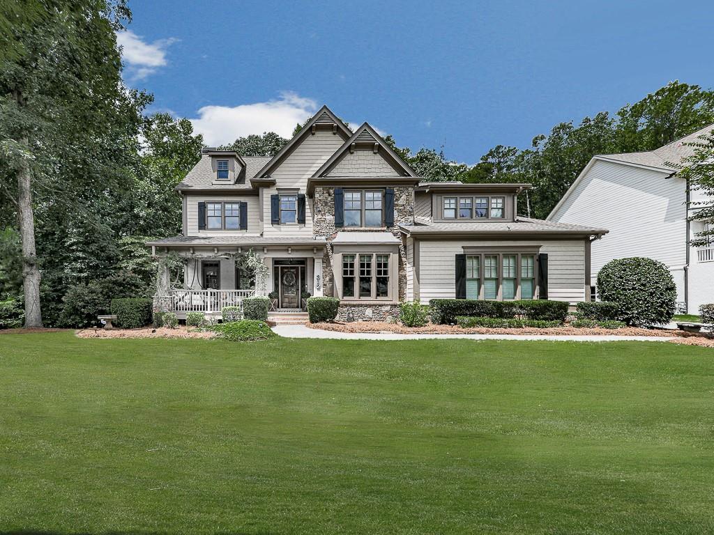 312 Peninsula Pointe Canton, GA 30115 - Photo 1 of 1 a front view of a house with a garden