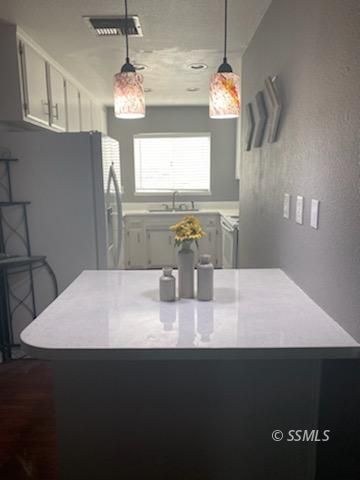 928 West St George Avenue Ridgecrest, CA 93555 - Photo 6 of 20 a bathroom with a sink and a mirror