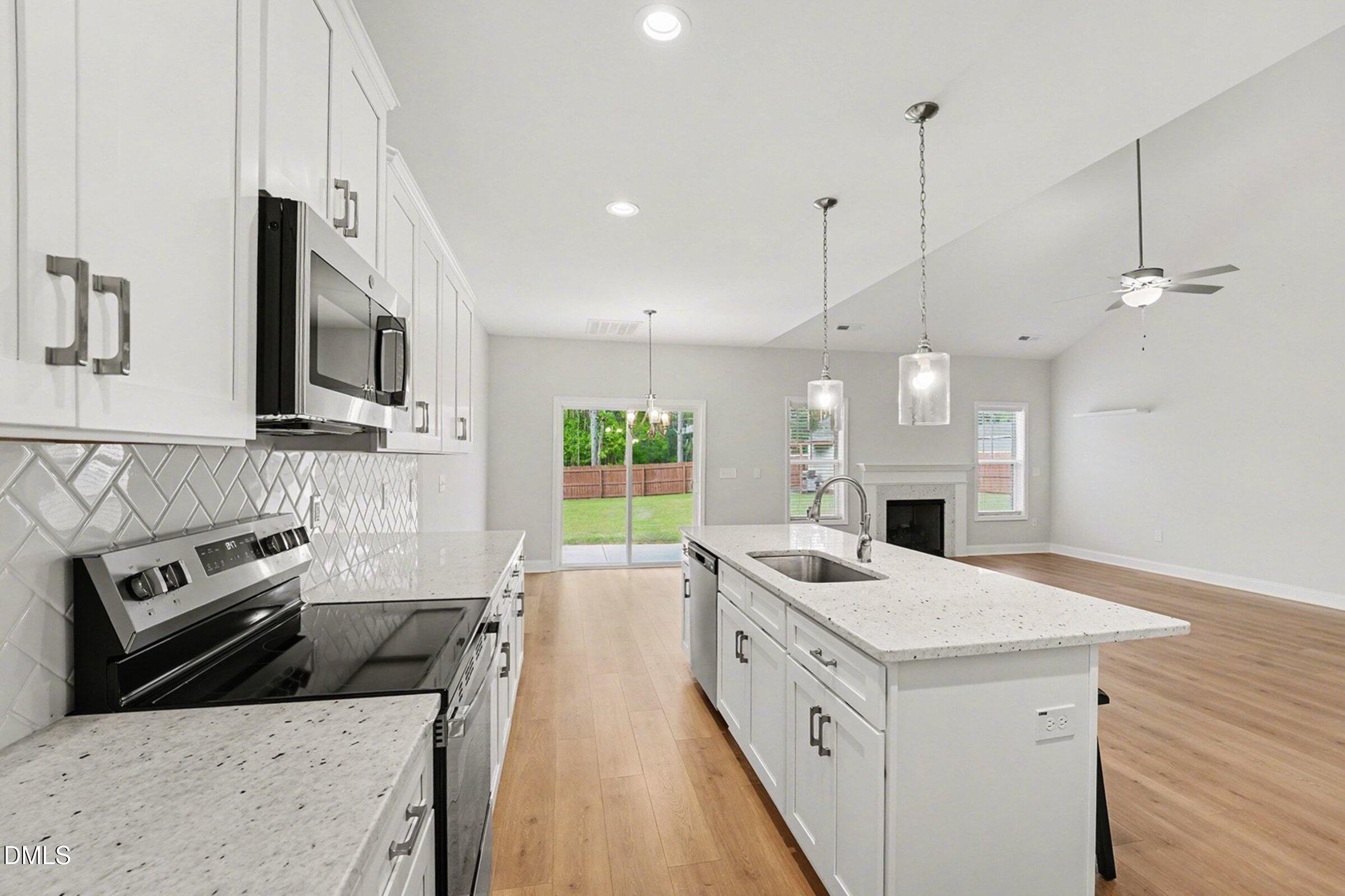 2815 Lemuel Black Road Spring Lake, NC 28390 - Photo 11 of 37 a kitchen with stainless steel appliances granite countertop a sink stove and refrigerator