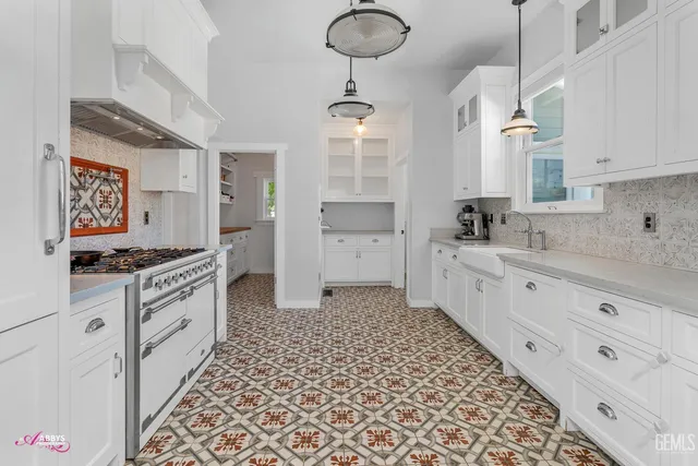 a stove top oven sitting inside of a kitchen
