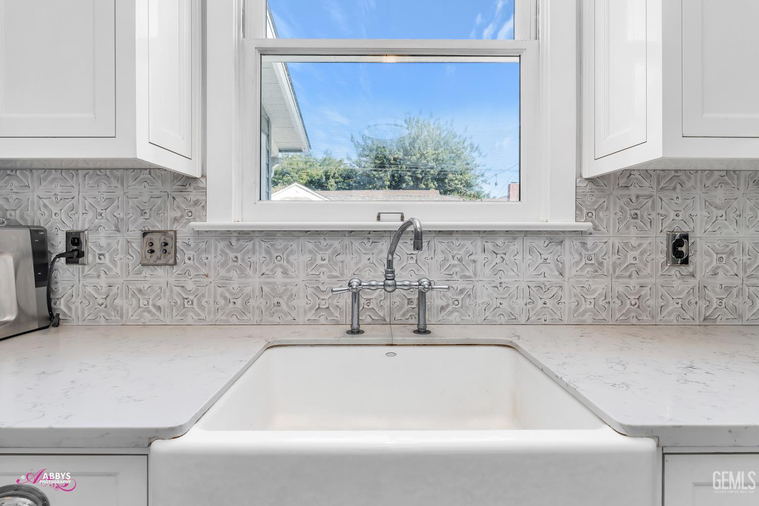 Undisclosed Address Bakersfield, CA 93301 - Photo 20 of 58 a bathroom with a granite countertop a sink and a window