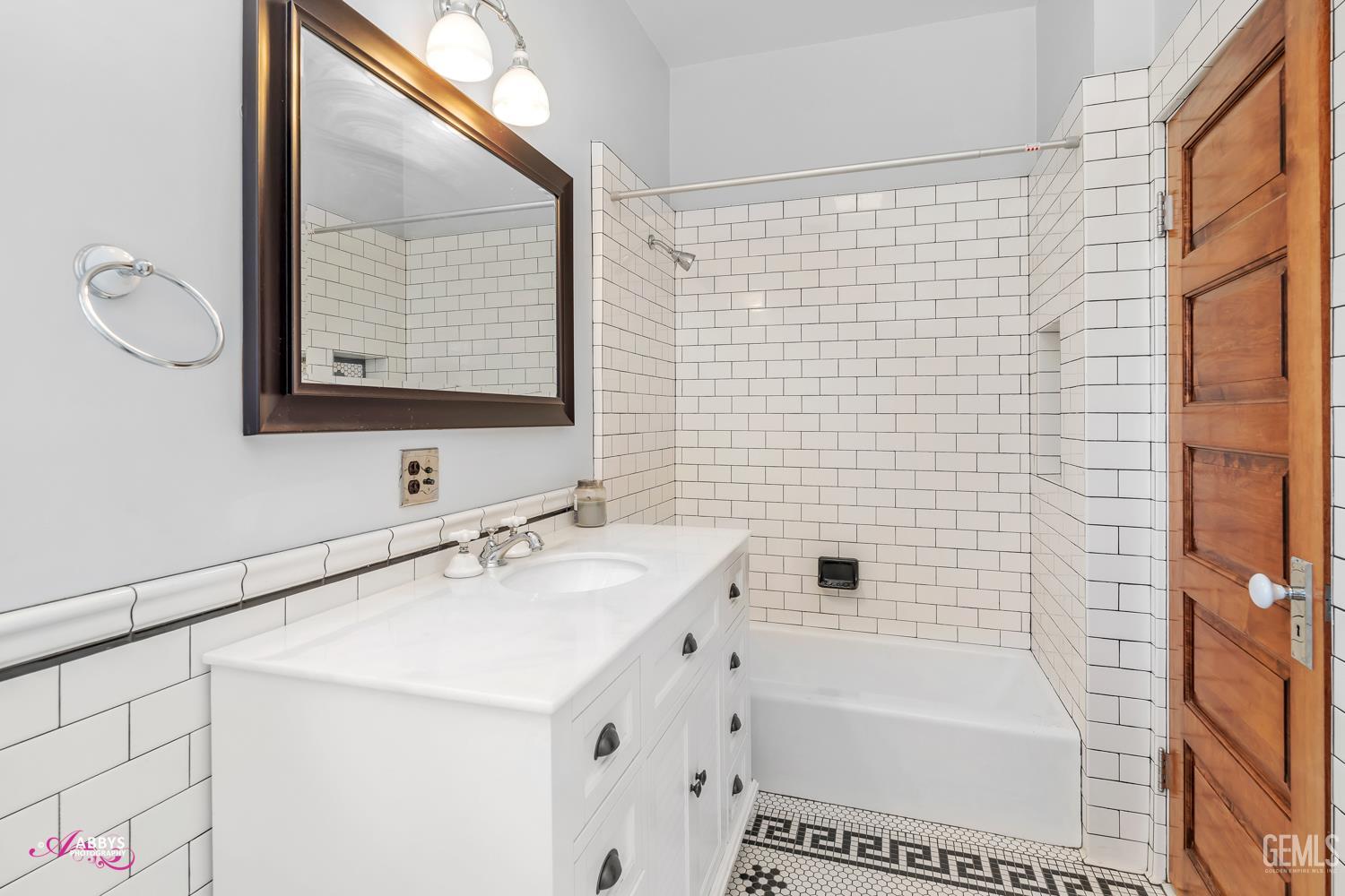 Undisclosed Address Bakersfield, CA 93301 - Photo 31 of 58 a bathroom with a tub a sink and a large mirror