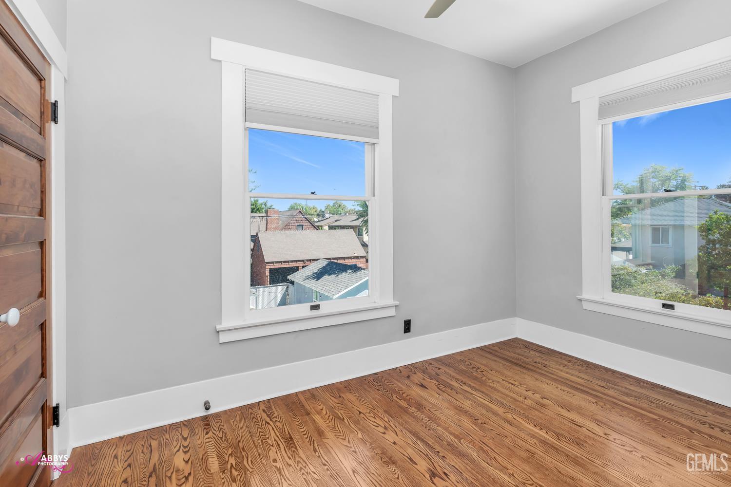 Undisclosed Address Bakersfield, CA 93301 - Photo 32 of 58 a view of an empty room with wooden floor and a window