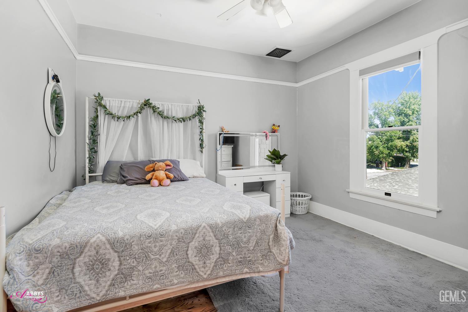 Undisclosed Address Bakersfield, CA 93301 - Photo 33 of 58 a bedroom with a bed a window and potted plants on the table