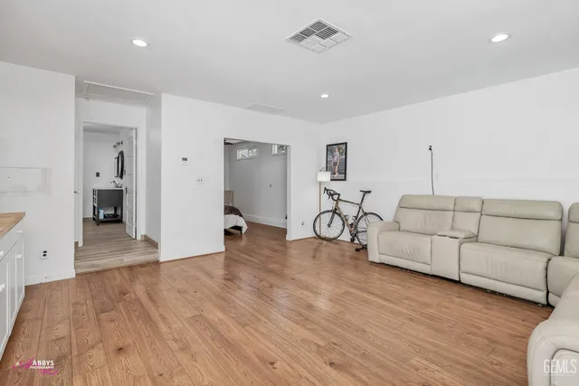 a kitchen with cabinets and wooden floor