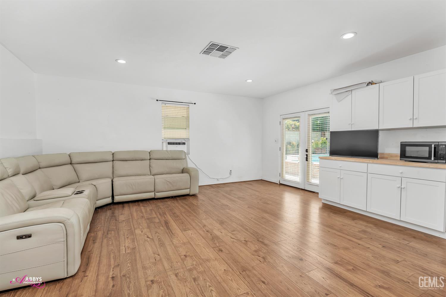 Undisclosed Address Bakersfield, CA 93301 - Photo 35 of 58 a living room with furniture and a wooden floor
