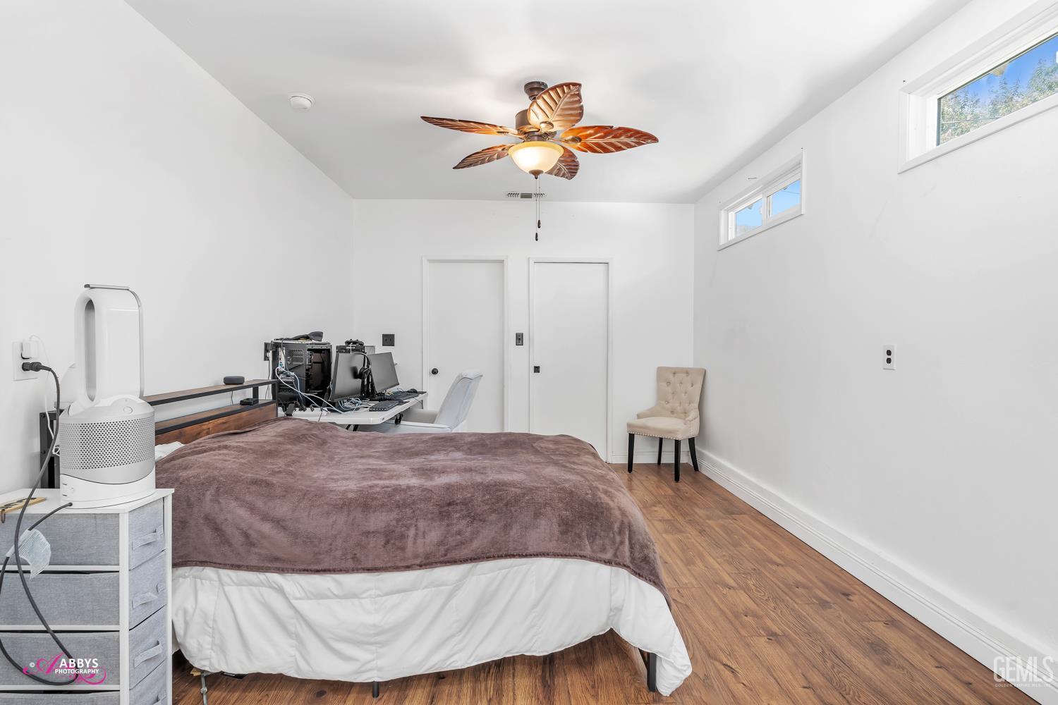 Undisclosed Address Bakersfield, CA 93301 - Photo 36 of 58 a bedroom with a bed and a chandelier