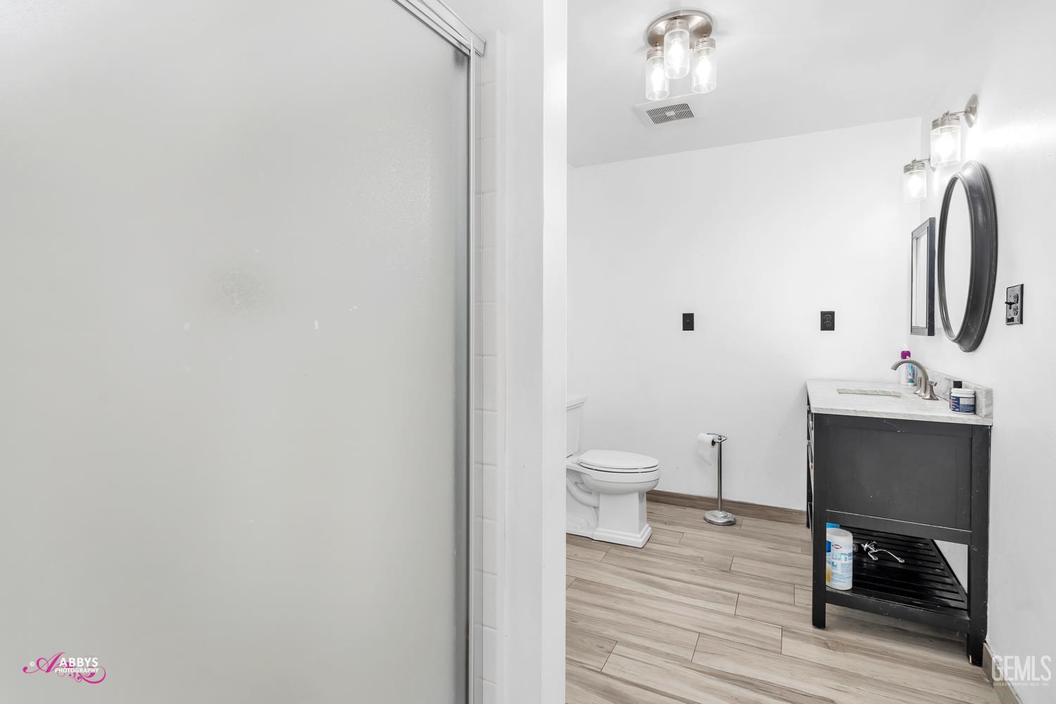 Undisclosed Address Bakersfield, CA 93301 - Photo 37 of 58 a bathroom with a sink and a mirror